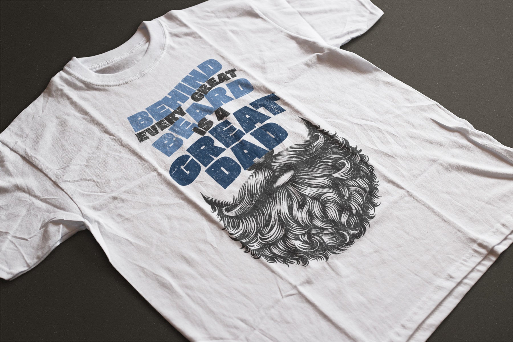 White graphic t-shirt with image of beard with the phrase "behind every great beard is a great dad" above the beard in blue font. Great for father's day and birthdays.