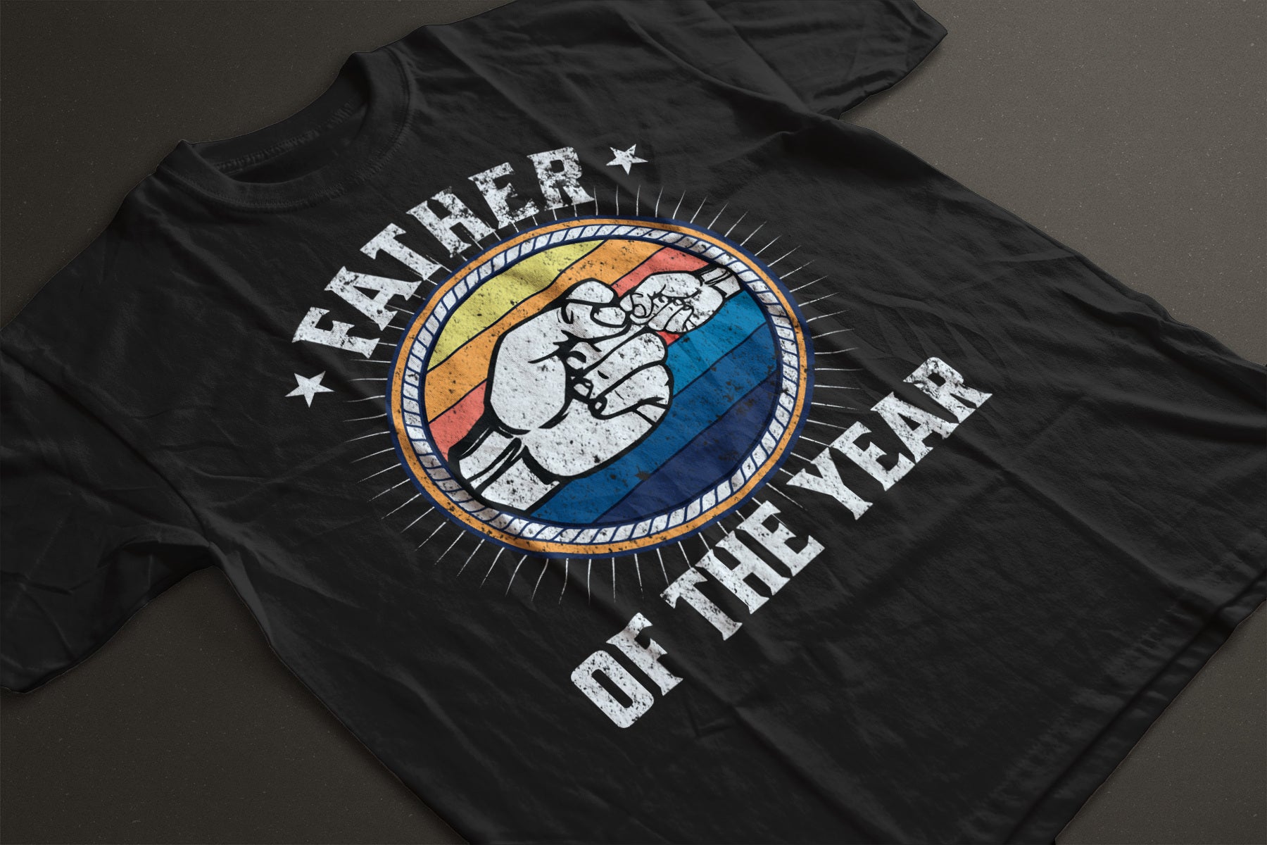 Father of the year t-shirt with image of father and child fist bump within a colorful circle design.