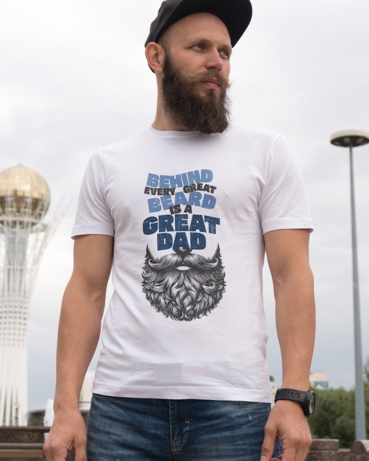White graphic t-shirt with image of beard withe words "behind every great beard is a great dad" above the beard in blue font.